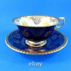 Cobalt and Gold Exterior with Floral Center on Beige Paragon Tea Cup and Saucer